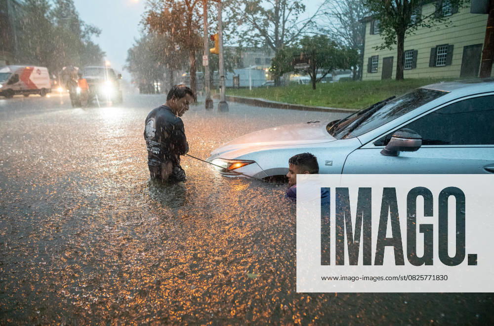 Plainfield, New Jersey, U.S: Men try to tow their car out of the rain swell during a flash flood on Watchung Avenue in Plainfield, New Jersey. Motorists and residents were left stranded in their cars, the local high school and reports of flooded homes. Earlier in July Plainfield suffered fatalities from a heavy storm that contained hail and heavy winds tearing down power lines and damaging homes in Plainfield along with other Central Jersey towns. Plainfield U.S - ZUMAp140 20250714_zap_p140_031