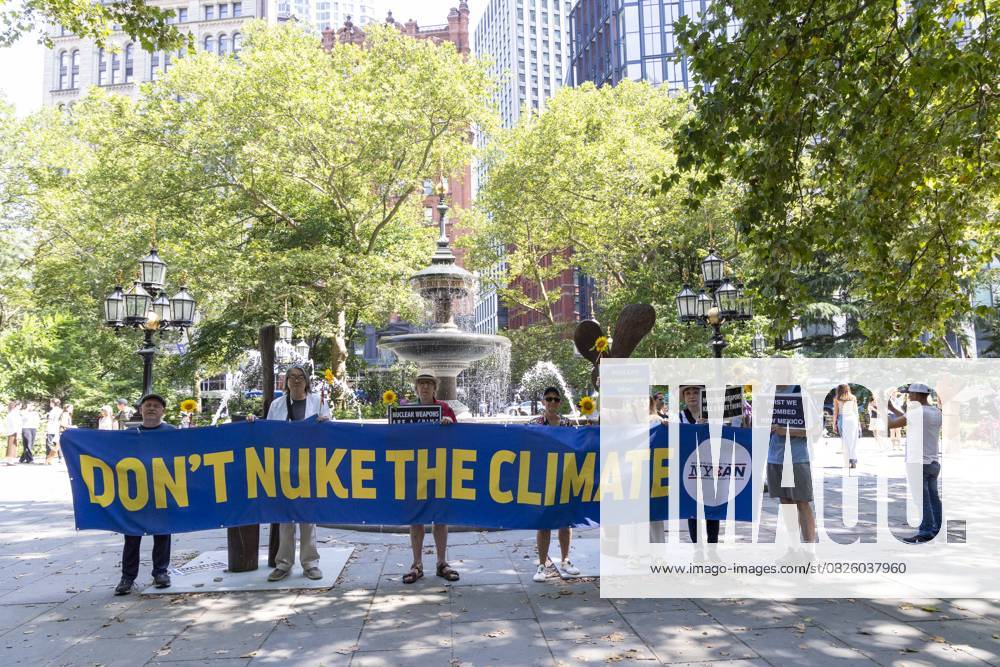 Members of New York Campaign To Abolish Nuclear Weapons (NYCAN) hold sunflowers and a banner and signs that read DON T NUKE THE CLIMATE NUCLEAR DISARMAMENT NOW! NUCLEAR WEAPONS KILL EVERYTHING FIRST WE BOMBED NEW MEXICO at a vigil in City Hall Park marking 80 years since the U.S. government s Trinity Test, the detonation of the first nuclear weapon on July 16, 1945 in the Tularosa Basin in New Mexico. The protest is held across the street from the original Manhattan Project offices at 270 Broadway in lower Manhattan. Demonstrators call for worldwide nuclear abolition and mourn for the illness and harm to people and lands from radioactive contamination caused by nuclear tests and atomic bombs. - ZUMAr174 20250716_znp_r174_015