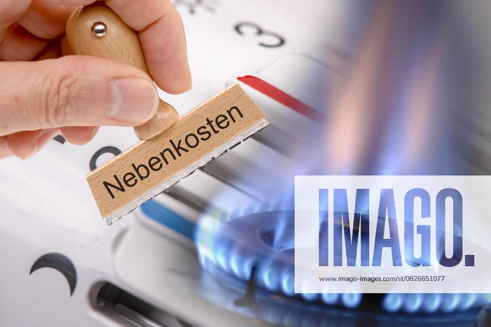 Utility costs of rent through heating A wooden stamp with utility costs printed on it is held in front of a gas flame and a thermostat for the heating FOTOMONTAGE