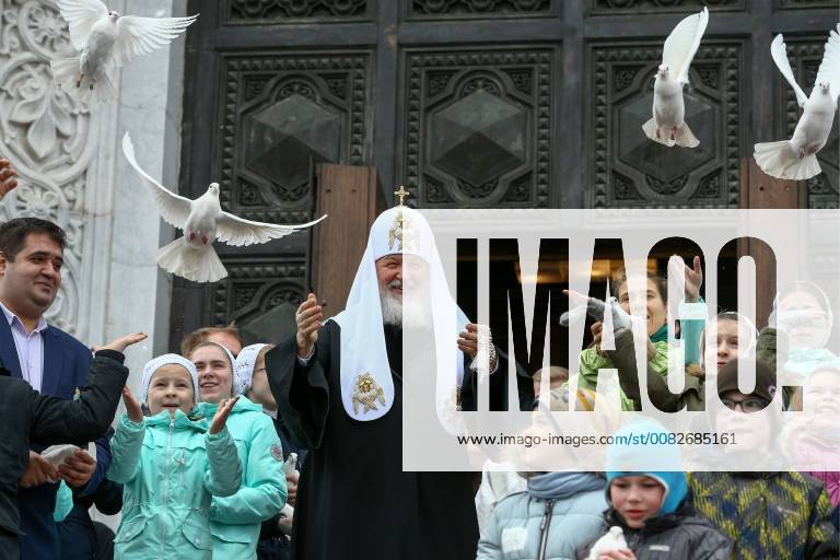 Patriarch Kirill of Moscow and all Russia (C) and Russian Orthodox believers look on as white doves are released after a Divine Liturgy celebrating the Annunciation of the Most Holy Mother of God at the Cathedral of Christ the Saviour. Mikhail Tereshchenko TASS TS07AD81