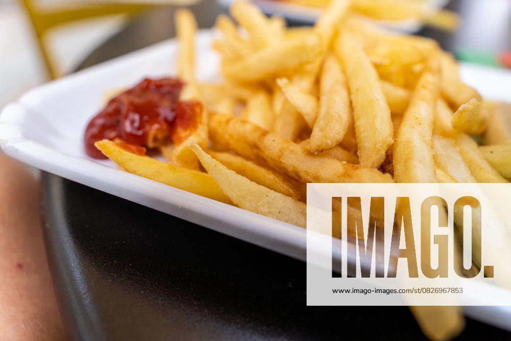 Malcesine, Lake Garda, Italy 20 July 2025: Crispy deep-fried chips with a dollop of ketchup - a popular classic snack that never goes out of fashion as a quick meal or side dish.