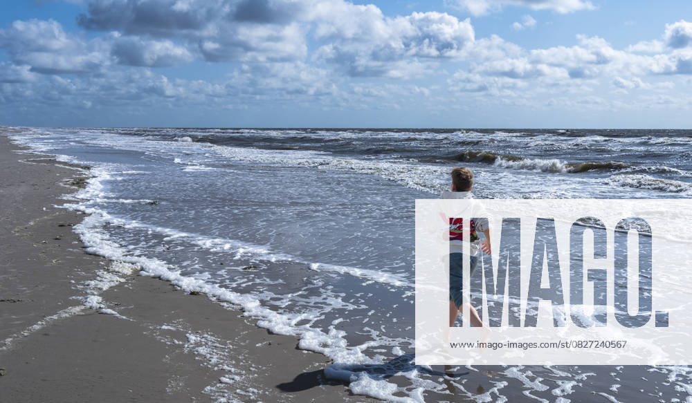 A boy runs along the beach of St Peter Ording 19 06 2025