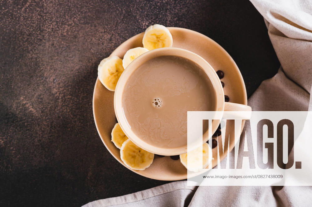 IMAGO Creative, Food, Trend, Iced Coffee Nahaufnahme von alternativem kalten Bananenkaffee in einer Tasse auf dem Tisch von oben Nahaufnahme von alternativem kalten Bananenkaffee in einer Tasse auf dem Tisch von oben (License=RF)