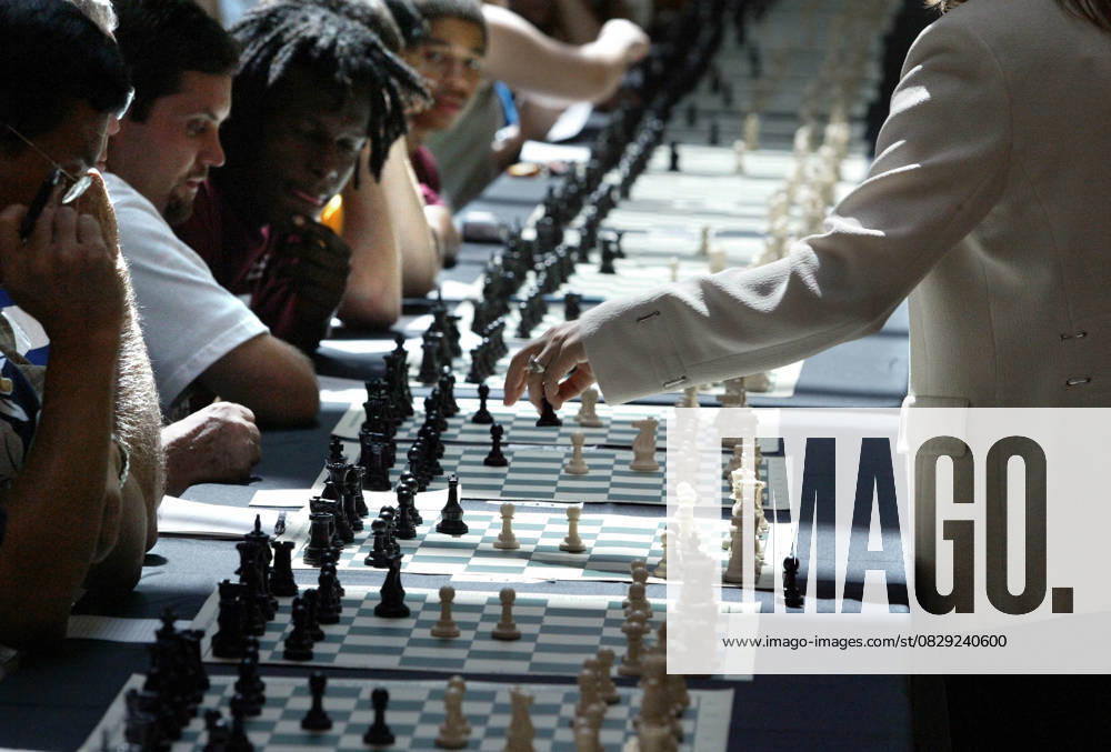 Woman Plays 350 Chess Matches Simultaneously Jul 30, 2005; Palm Beach, FL, USA; Grandmaster Susan Polgar (cq) attempted to set a Guinness World Record Monday at The Gardens mall by playing 350 chess matches simultaneously. The first woman to become a Grandmaster, she is currently the 1 ranked female chess player in the United States. The purpose of the event is to promote U.S. Chess and raise money for the Susan Polgar Foundation. More than 350 Chess stations were set up in the Gardens Mall. Each chess station consisted of a table and chair, a chess board and pieces. Each player was assigned to a station. Susan walked along the rows of tables. At each station she observed her opponent move, responded with her move, and then walked to the
