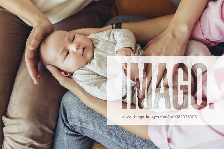 Midwife and mother giving newborn baby a belly massage to help with digestion model released Symbolfoto property released MFF04397