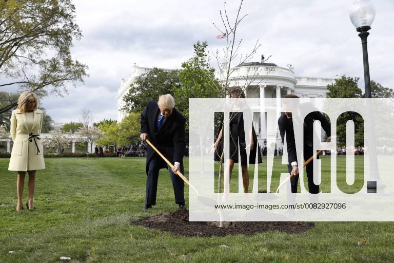 U.S. President Donald Trump with France s president Emmanuel Macron and First Ladies Melania Trump and Brigitte Macron plant a tree, a gift from the President and Mrs. Macron, on the South Lawn of the White House in Washington, DC on Monday, April 23, 2018. WAX20180423118 YurixGripas