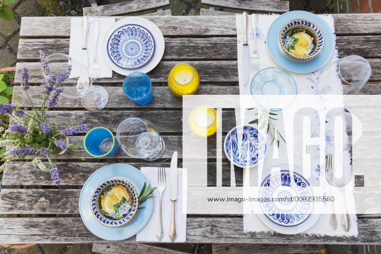 Garden table laid with colorful plates and bowls property released GWF05465