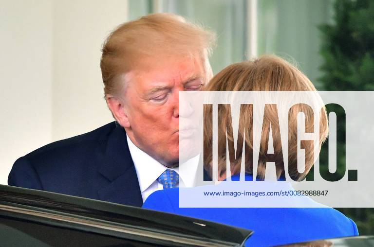 President Donald Trump kisses Chancellor Merkel of Germany as she arrives at the White House in Washington, D.C. April 27, 2018. WAP20180427310 KEVINxDIETSCH