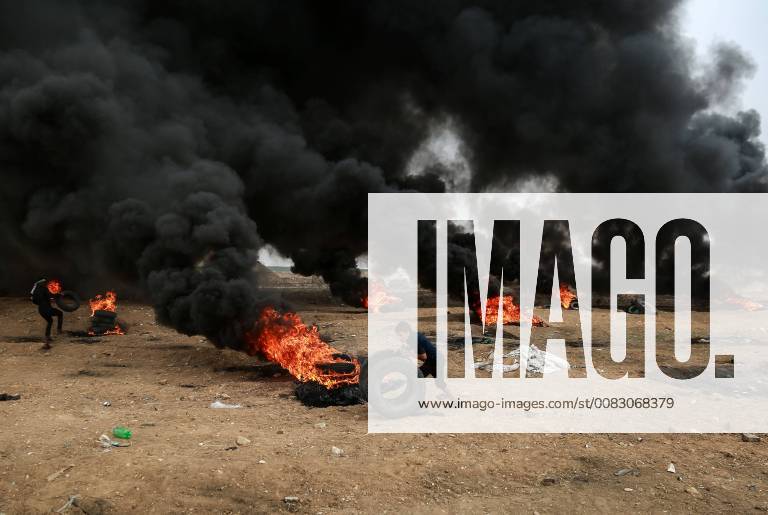 (180504) -- GAZA, May 4, 2018 -- A Palestinian boy rolls tires during clashes with Israeli troops on the Gaza-Israel border, east of Gaza City, on May 4, 2018. Clashes broke out Friday between dozens of Palestinian protestors and Israeli soldiers in eastern Gaza Strip close to the border with Israel during the sixth Friday of rallies and protests called the Great March of Return. ) (wtc) MIDEAST-GAZA-CLASHES Stringer