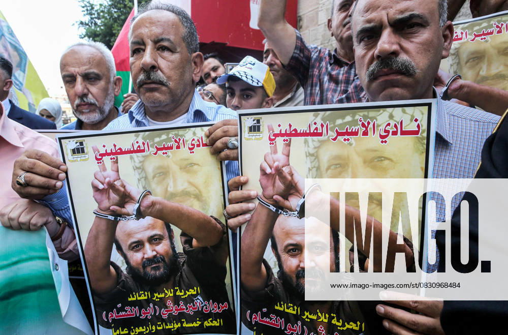 Protesters hold pictures of Palestinian prisoner Marwan Barghouti, who is serving a five life sentences and 40 years in Israeli prisons, during a protest demanding his release and the release of all prisoners in the city of Nablus. Nablus Palestine - ZUMAs197 20250820_aaa_s197_043