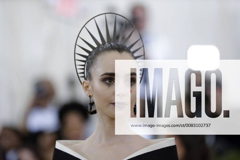 Lily Collins arrives on the red carpet at The Metropolitan Museum of Art s Costume Institute Benefit Heavenly Bodies: Fashion and the Catholic Imagination at Metropolitan Museum of Art in New York City on May 7, 2018. NYP20180507828 JOHNxANGELILLO