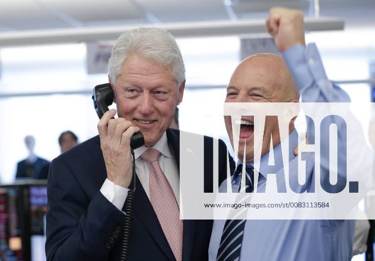 BTIG Co-Founder Steven Starker stands with former President of the United States Bill Clinton who speaks to a client at the 2018 BTIG Commissions for Charity Day in New York City on May 8, 2018. NYP20180508105 JOHNxANGELILLO