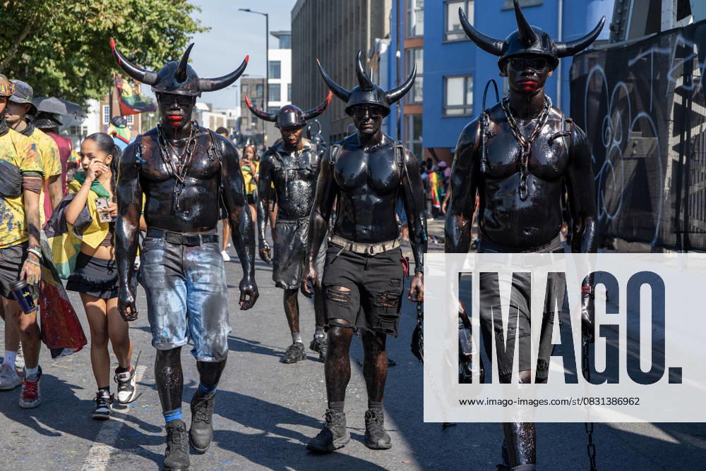Notting Hill Carnival 2025 in London, UK - 24 Aug 2025 The Jab Jab masquerades walk on the street with chains during the Notting Hill Carnival in London. The Notting Hill Carnival is one of the world s largest street festivals. It is an annual Caribbean Carnival that has taken place in London since 1966 on the streets of Notting Hill over the bank holiday weekend in August. London United Kingdom
