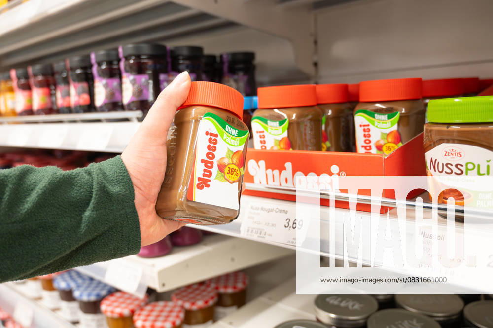 Customer holds Nudossi Hazelnut spread in the Hand, Grocery shopping, Price increase, high Cost of living and Inflation, Supermarket in Trier, Germany, 26 August 2025 1133603040