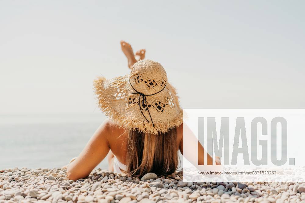 Beach Relaxation woman lies on a pebble beach, legs raised, and arms spread out. The concept of travel, vacation at sea Beach Relaxation woman lies on a pebble beach, legs raised, and arms spread out. The concept of travel, vacation at sea., model released, , property released, , 63305720.jpg RECORD DATE NOT STATED