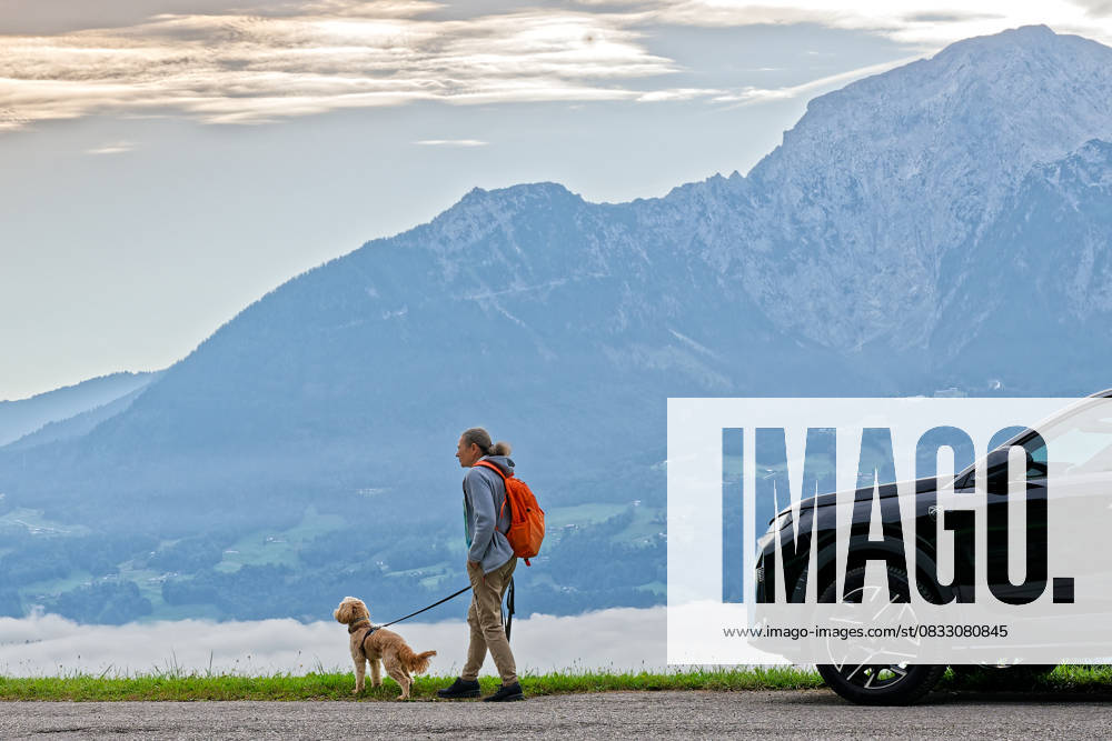 Finally free time The hike of the woman with her dog leads into the Berchtesgadener Land , with the mountain massif of the Hoher Göll in the background Ramsau near Berchtesgaden Berchtesgadener Land Bavaria Germany