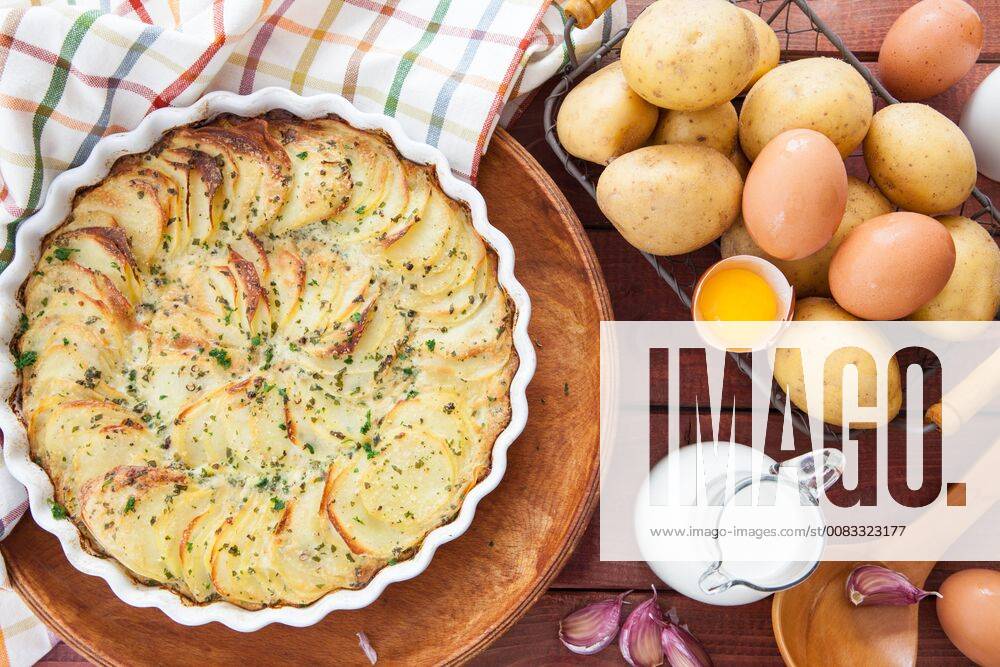 Homemade potato gratin in casserole dish with ingredients Homemade potato gratin 1079704950