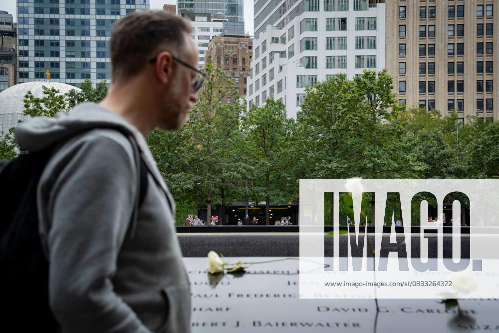 A visitor walks by flowers placed on the 9 11 memorial in Lower Manhattan on the day before the anniversary date. This year marks 24 years since the Twin Towers were attacked in the deadliest terror attack in history. New York USA - ZUMAg280 20250910_znp_g280_010