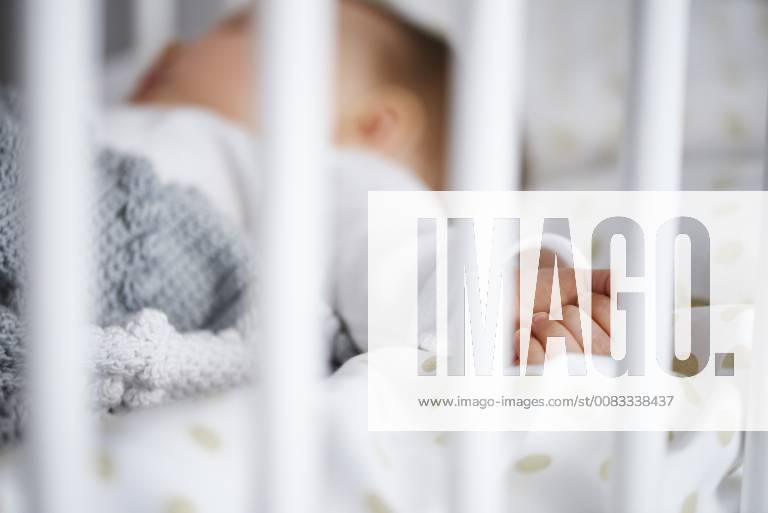 Defocused shot of baby lying in crib model released Symbolfoto property released ABIF00330