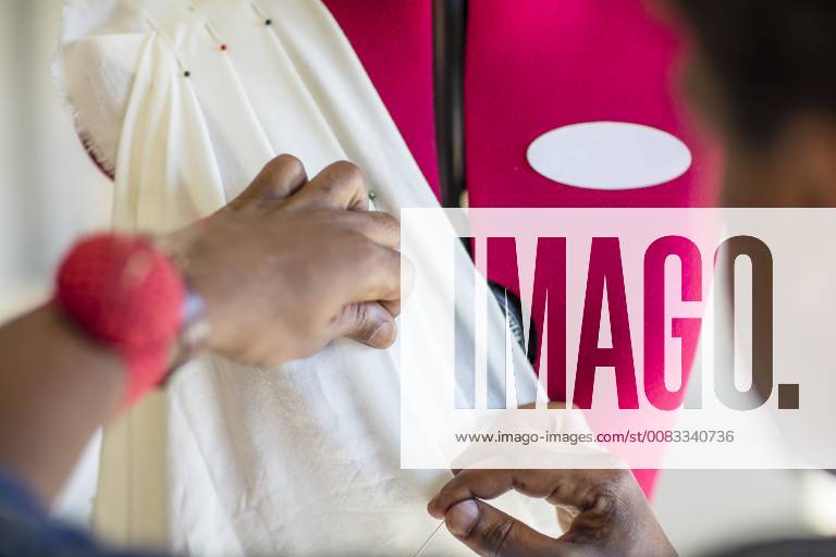 Close-up of tailor working on dress in studio model released Symbolfoto property released ZEF15308