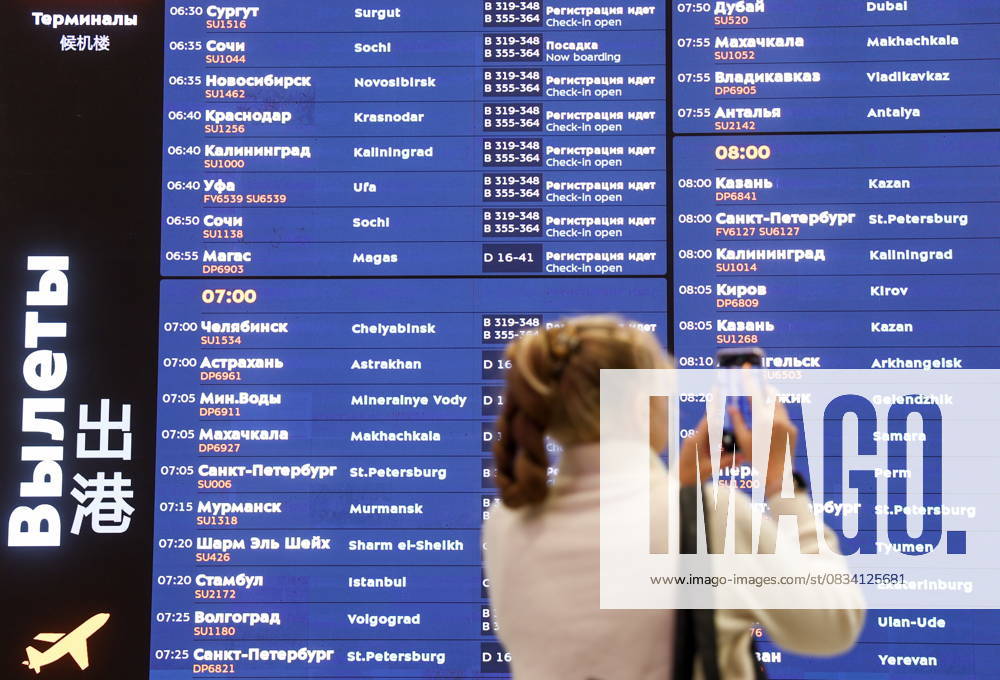 RUSSIA, MOSCOW REGION - SEPTEMBER 17, 2025: A woman takes pictures of a flight information display board as an Aeroflot flight prepares to depart from Sheremetyevo International Airport to Krasnodar. On 11 September 2025, Krasnodar International Airport resumed operations, with the first civil flight since 2022 expected to land there on September 17. Sofya Sandurskaya TASS 84063520