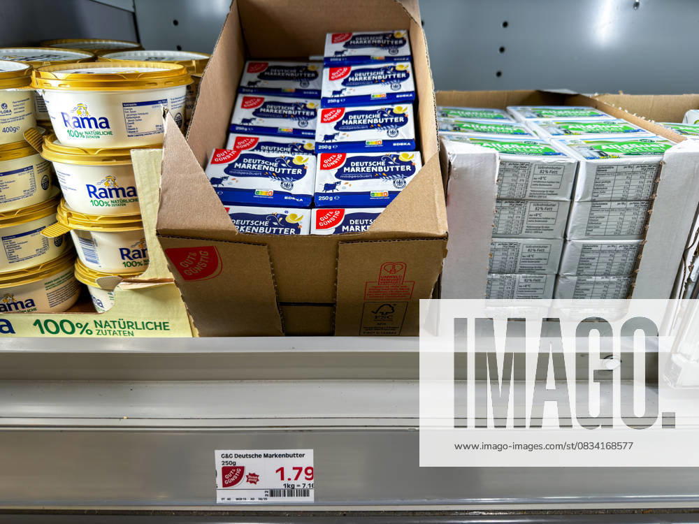 Several packs of German brand butter in the refrigerated section of a supermarket. The dairy product is sold in 250 gram packs. Price tag 1.79 euros
