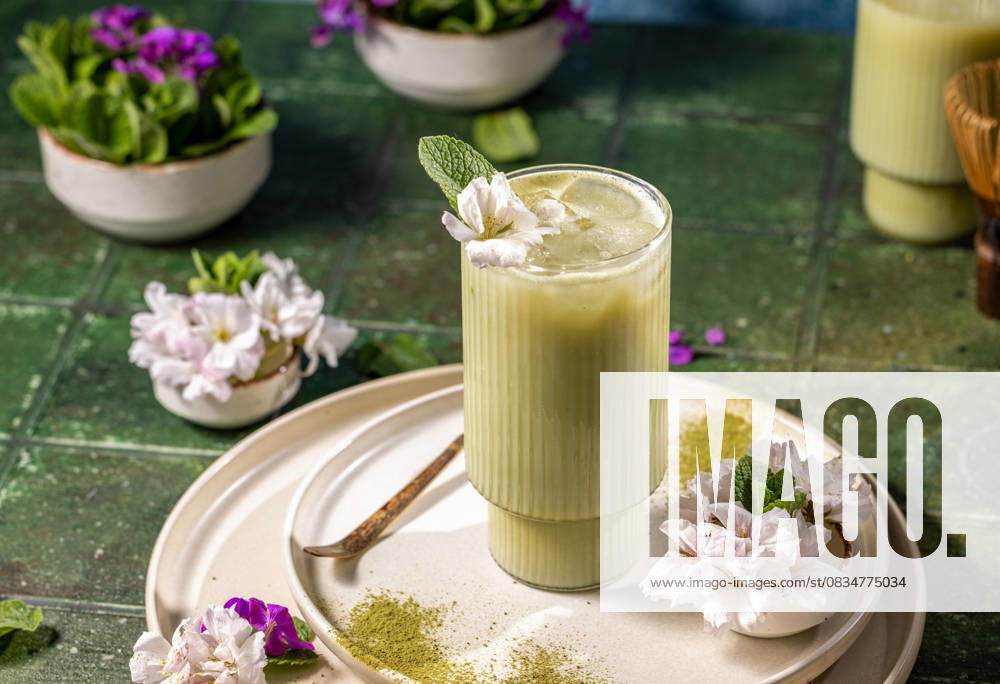 Iced matcha latte garnished with fresh mint and cherry blossoms Refreshing iced matcha latte decorated with fresh mint and delicate cherry blossoms, served on a stylish plate with matcha powder, 94709066.jpg RECORD DATE NOT STATED