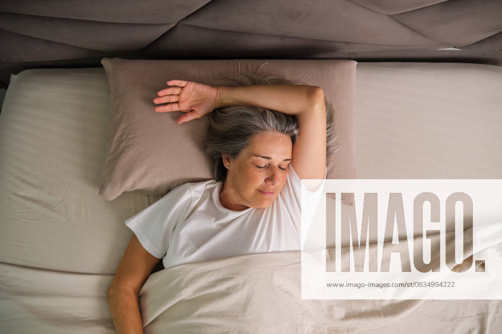 Person sleeping comfortably in bed during morning routine model released, Symbolfoto property released, CVMF00200