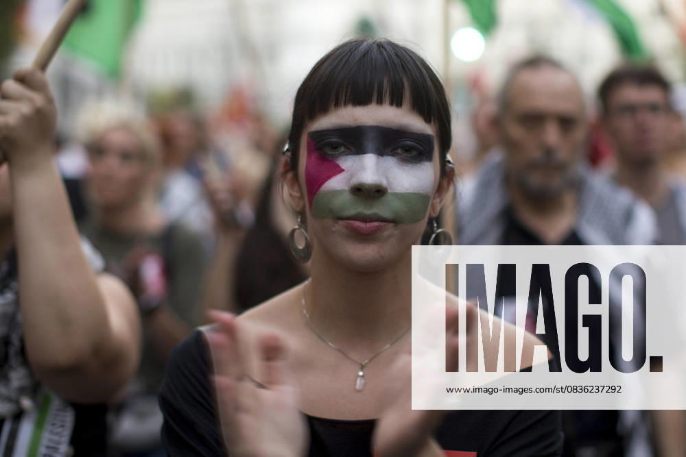 A protester with the Palestinian flag painted on her face applauds during a pro-Palestinian demonstration in central Madrid in solidarity with the Palestinian people in the face of Israeli attacks and condemning the interception by Israeli forces of the Global Sumud Flotilla ships. Madrid Spain - ZUMAs296 20251004_znp_s296_009