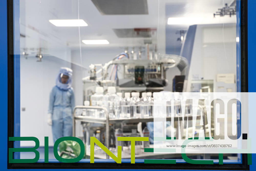 BioNTech Covid-19 Vaccine manufacturing facility in Germany MARBURG, GERMANY - MARCH 29: Employees in special suits test the procedures for the manufacturing of the messenger RNA (mRNA) for the Covid-19 vaccine in German company BioNTech, in Marburg, Germany on March 29, 2021. BioNTech Marburg s coronavirus vaccine production target will be 2.5 billion doses for 2021, up from 2.3 billion as it is considered as one of the largest manufacturing facilities producing mRNA vaccines in the world. The Pfizer-BioNTech vaccine was developed by Ozlem Tureci and Ugur Sahin, a couple who are children of Turkish immigrants in Germany. Berlin Germany. Editorial use only. Please get in touch for any other usage.