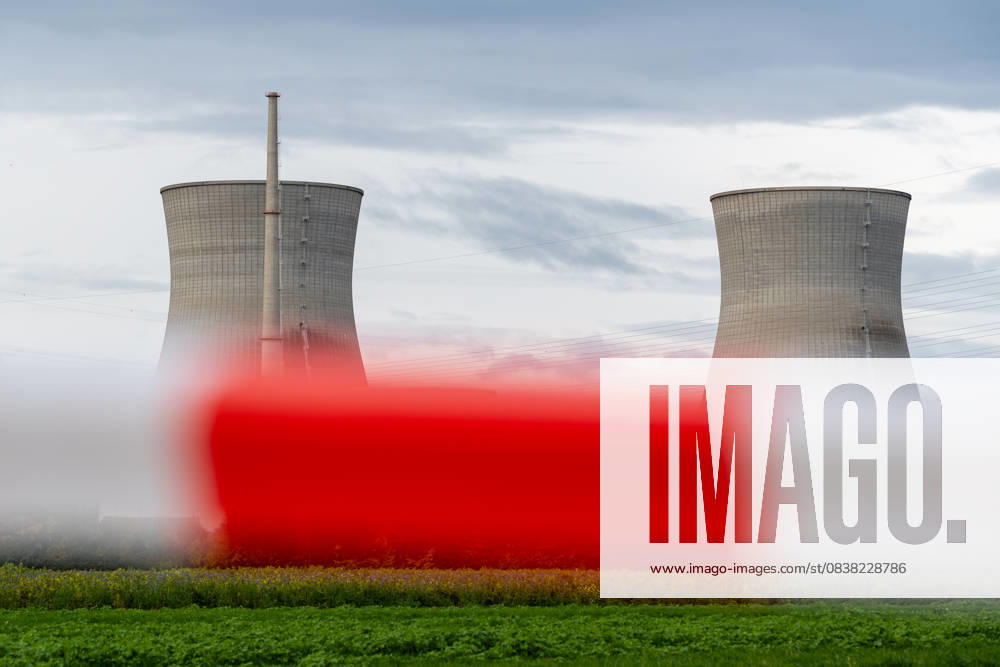 The nuclear power plant on the day the cooling towers of the decommissioned Gundremmingen nuclear power plant (AKW KRB) in Bavaria were blown up. The two 160-metre-high towers will be blown up at 12 noon on Saturday, October 25, 2025. Symbolic photo nuclear phase-out, barrier tape and warning beacon in the foreground, the nuclear power plant in the background
