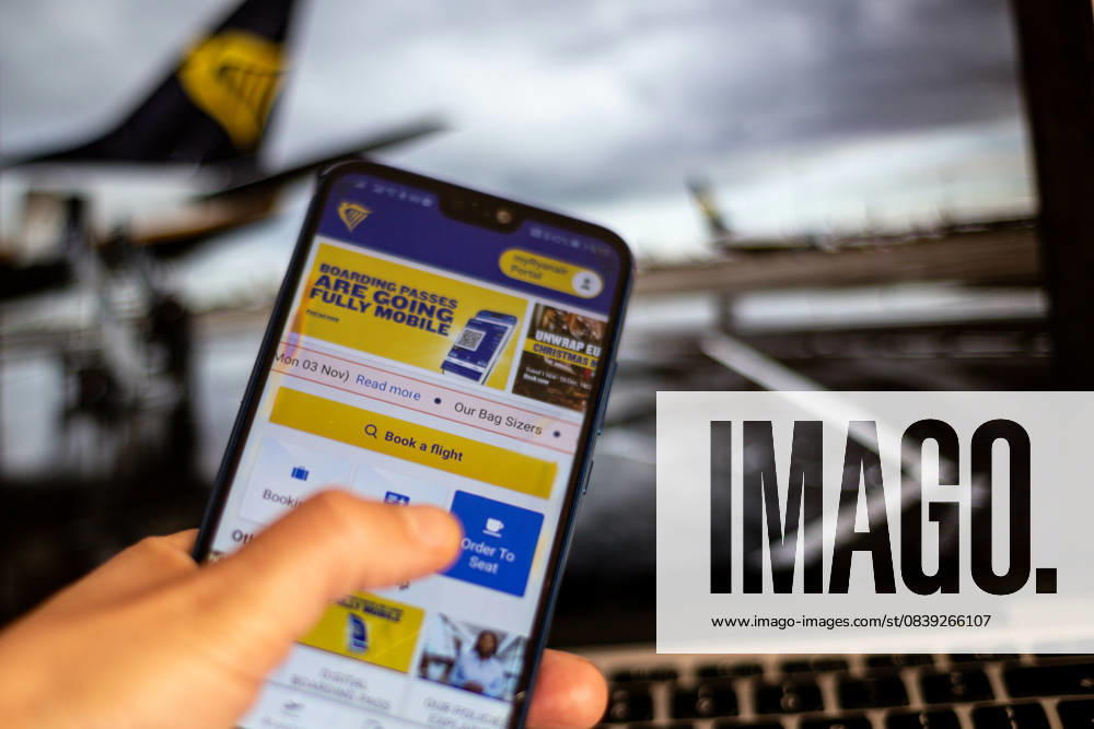 Ryanair Raises Passenger Outlook In this photo illustration Ryanair booking app is shown on a mobile phone against a photograph of Ryanair planes displayed on a computer screen as the company expects to take more passenger next year - November 3, 2025. London United Kingdom