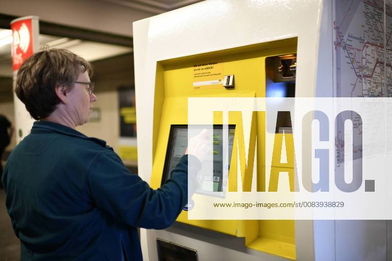 Elderly woman buys ticket at ticket vending machine BVG Berliner Verkehrsbetriebe Berlin Germany Berlin