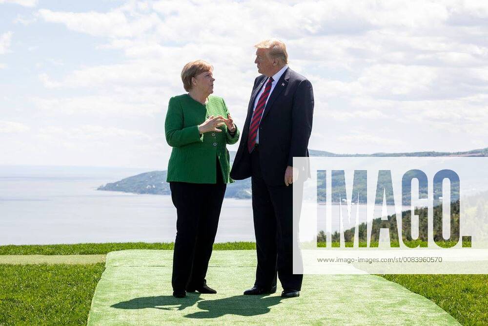Charlevoix, Quebec, Canada - U.S. President Donald Trump, right, chats with German Chancellor Angela Merkel during the G7 Summit at the gardens of the Fairmont Le Manoir Richelieu June 8, 2018 in Charlevoix, Quebec, Canada. Charlevoix Canada - ZUMAp138 20180608_zaa_p138_006