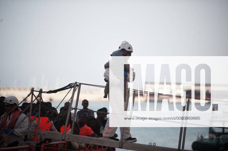 Malaga, Malaga, Spain - A baby migrant, who was rescued from a dinghy in the Mediterranean Sea, is carried by rescue worker after his arrival at Port of Malaga. Members of the Spanish Maritime Safety rescued 314 migrants aboard six dinghies near the Malaga coast and brought at Port of Malaga, where they were assisted by the Spanish Red Cross. A total of 769 migrants were rescued this Saturday from Alboran sea, Canary Islands and Strait of Gibraltar aboard 25 dinghies. Malaga Spain - ZUMAs197 20180623_zaa_s197_067