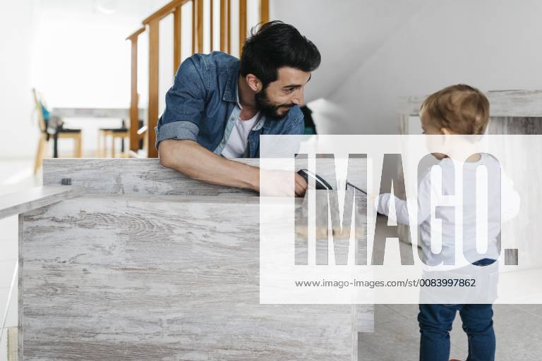 Father and daughter assembling a wooden table at home model released Symbolfoto property released JRFF01642