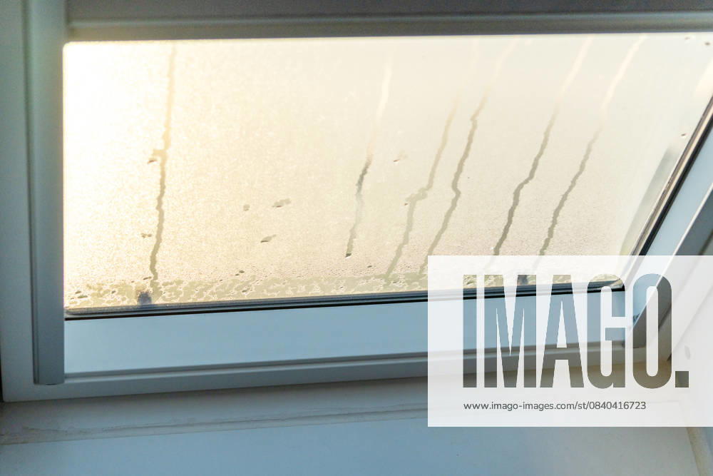 A fogged-up skylight on a cold winter day. Moisture and condensation collect on the pane, revealing typical problems associated with cold temperatures, high humidity, and poor insulation in the interior.