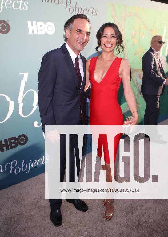 HOLLYWOOD, CA - JUNE 26: Emmanuelle Vaugier, Vince Calandra, arriving to the Premiere Of HBO s Sharp Objects at The Cinerama Dome in Hollywood, California on June 26, 2018.