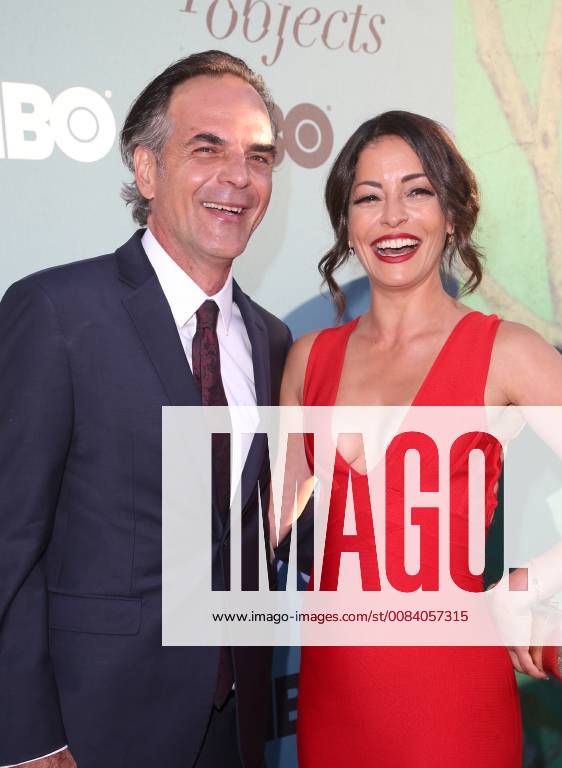 HOLLYWOOD, CA - JUNE 26: Emmanuelle Vaugier, Vince Calandra, arriving to the Premiere Of HBO s Sharp Objects at The Cinerama Dome in Hollywood, California on June 26, 2018.