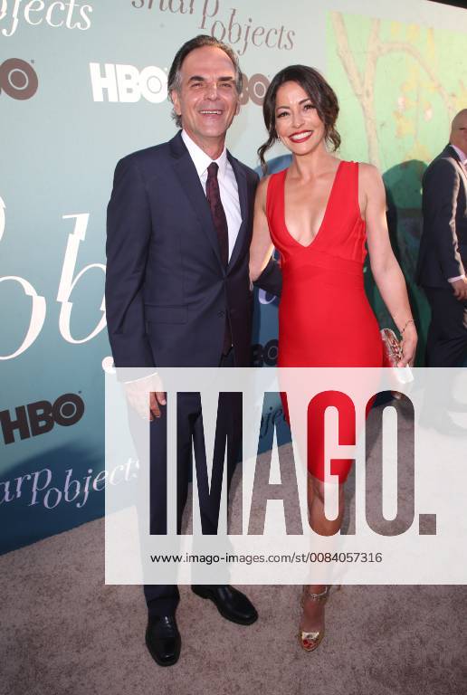 HOLLYWOOD, CA - JUNE 26: Emmanuelle Vaugier, Vince Calandra, arriving to the Premiere Of HBO s Sharp Objects at The Cinerama Dome in Hollywood, California on June 26, 2018.