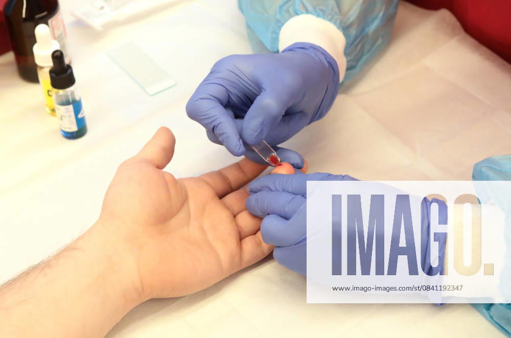 Medical worker performs a rapid finger-prick blood test on a donor during a medical check-up on the second floor of the Teplokrovni mobile hub at the Warm Weekend event, Kyiv, Ukraine, on November 20, 2025. The first floor features an interactive exhibition on blood and donation (Photo by Volodymyr Tarasov Ukrinform) Warm Weekend at Teplokrovni mobile hub