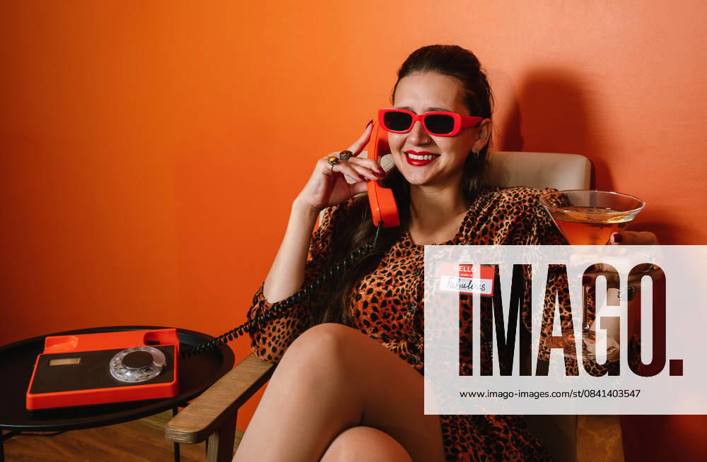 Retro portrait with leopard print dress and phone in hand model released, Symbolfoto, AAF00301