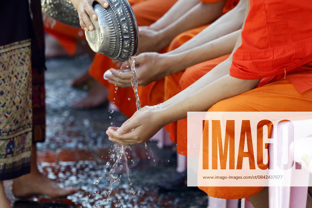 Buddhist ceremony. Worshipper washing the hands of Buddhist monks. Purification ritual. Luang Prabang. Luang Prabang. Laos. Luang Prabang Laos
