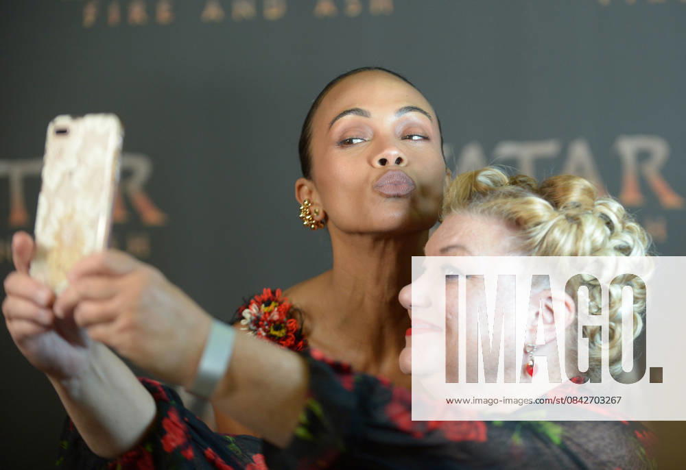 MIAMI, FLORIDA - DECEMBER 12: Zoe Saldana take a selfie with member of the press during the Miami Special Screening of Avatar: Fire and Ash at AMC Sunset Place 24 in Miami, Florida on December 12, 2025.