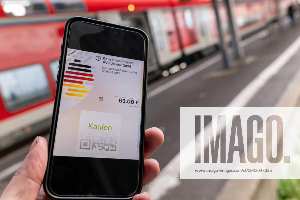 Germany ticket with new price at train station 17 12 25, Limburg Symbol photo, illustration image, symbol image, illustration photo, everyday scene A smartphone shows the digital Germany ticket with a price of 63 euros The