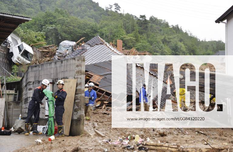 Torrential rains in western Japan Rescue workers are seen near damaged houses in Kumano, Hiroshima Prefecture on July 8, 2018, following torrential rains that hit a wide area of western Japan.
