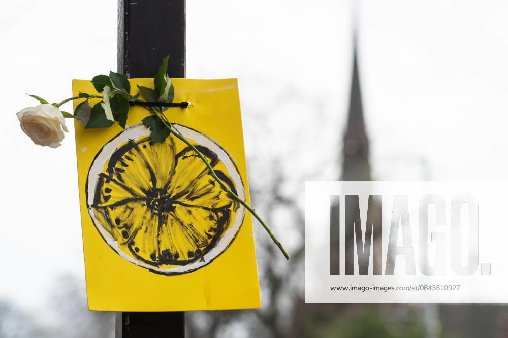 A painting of a lemon and a rose adorn the side of the road ahead of the funeral procession of Gary Mani Mounfield, Bass Player in the Stone Roses and Primal Scream, in Heaton Moor, Stockport on 22 December 2025. The Stone Roses dopted the lemon as a symbol of rebellion and counter-culture, featuring it prominently on their iconic debut album cover. 22 12 2025 Stockport Greater Manchester England Heaton Moor