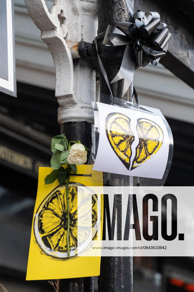 Paintings of a lemon and roses adorn the side of the road ahead of the funeral procession of Gary Mani Mounfield, Bass Player in the Stone Roses and Primal Scream, in Heaton Moor, Stockport on 22 December 2025. The Stone Roses dopted the lemon as a symbol of rebellion and counter-culture, featuring it prominently on their iconic debut album cover. 22 12 2025 Stockport Greater Manchester England Heaton Moor