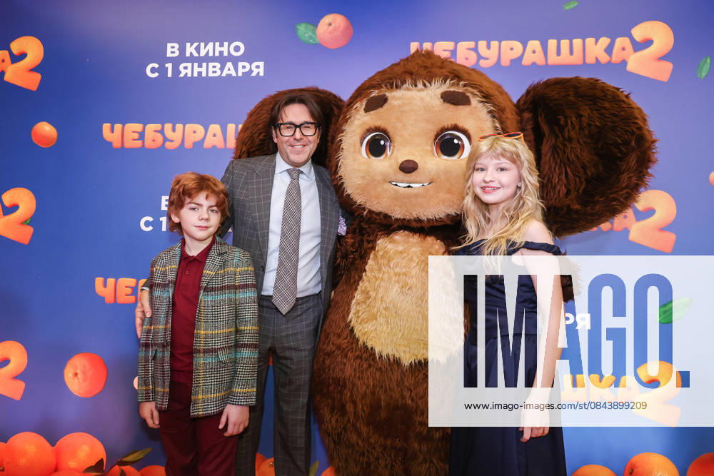 RUSSIA, MOSCOW - DECEMBER 24, 2025: Actor Ilya Kondratenko, TV host Andrei Malakhov (L-R) and actress Yeva Smirnova pose with an artist cosplaying the title character on the red carpet during the premiere of the family comedy Cheburashka 2 by Dmitry Dyachenko at the KARO 11 Oktyabr cinema on Novy Arbat Street (New Arbat Avenue). Valery Sharifulin TASS 86691917