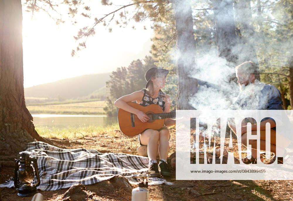 Couple, play and guitar at campfire outdoor with music performance, summer vacation and romantic getaway. Happy, people and instrument with travel, bonding together and creative talent of activity Couple, play and guitar at campfire outdoor with music performance, summer vacation and romantic getaway. Happy, people and instrument with travel, bonding together and creative talent of activity., model released, , 62974620.jpg RECORD DATE NOT STATED